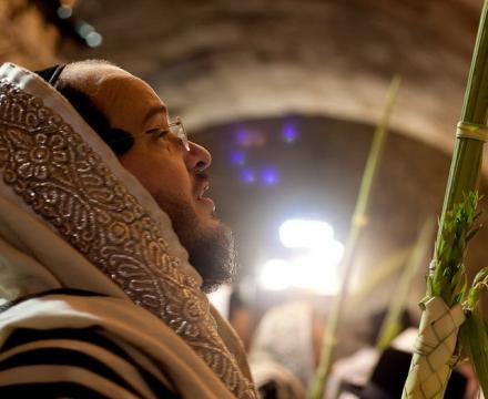 Holding the Four Species during Sukkot prayers. Photo: Flash90